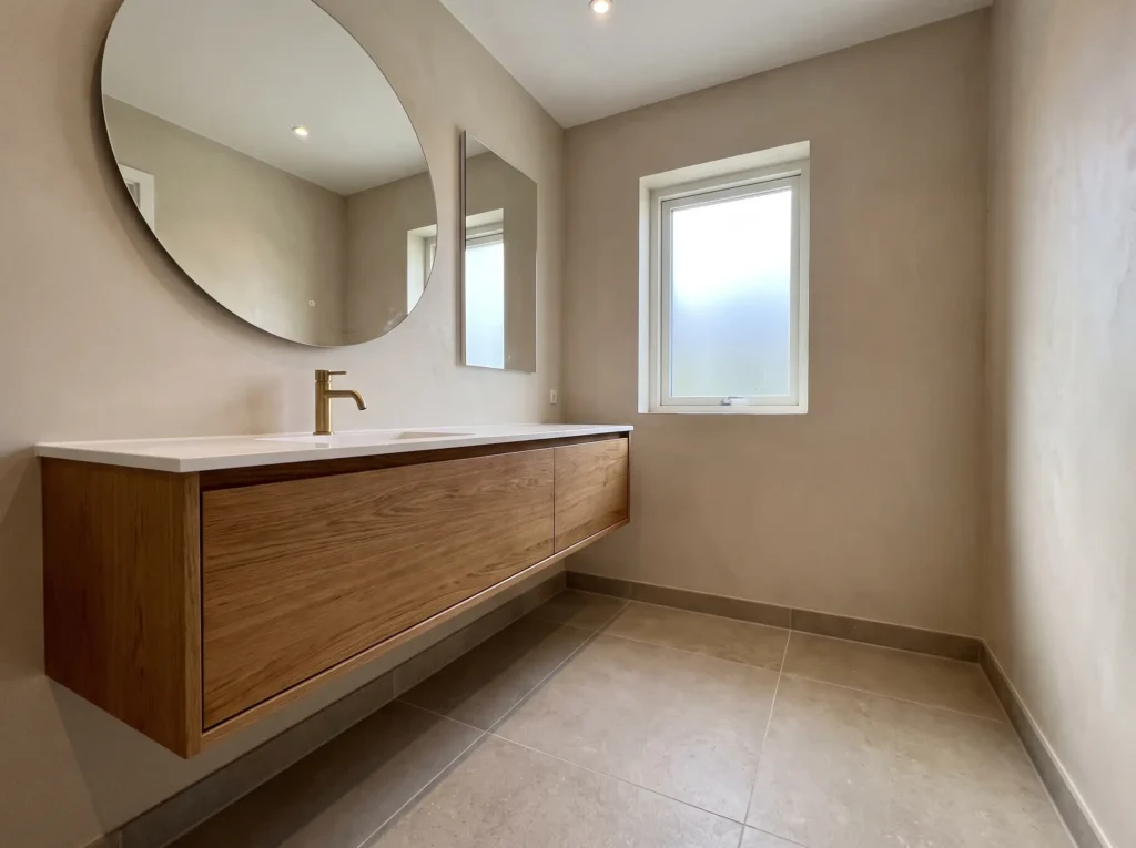 Modern small bathroom remodel with floating vanity and brass hardware