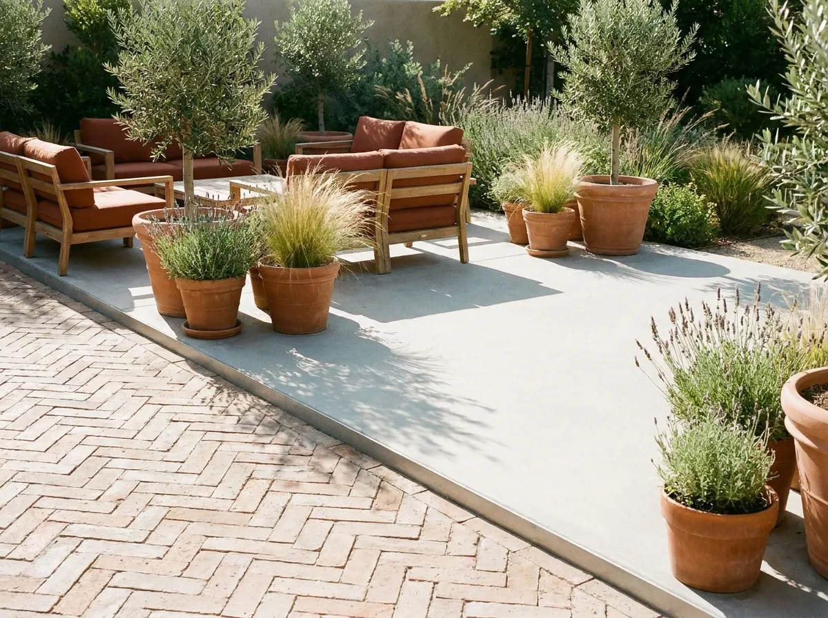 Concrete Patio Ideas That Still Look Good After Ten Winters 4 Herringbone paver patio laid beside a poured concrete slab in a sunny backyard