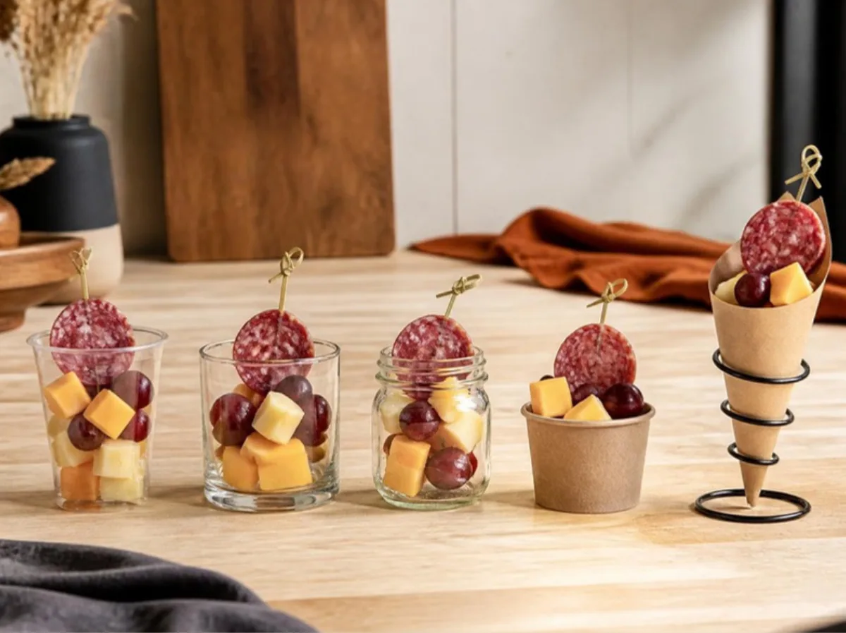 Five container types for charcuterie cups: clear plastic cup, glass tumbler, mason jar, paper dessert cup and cone